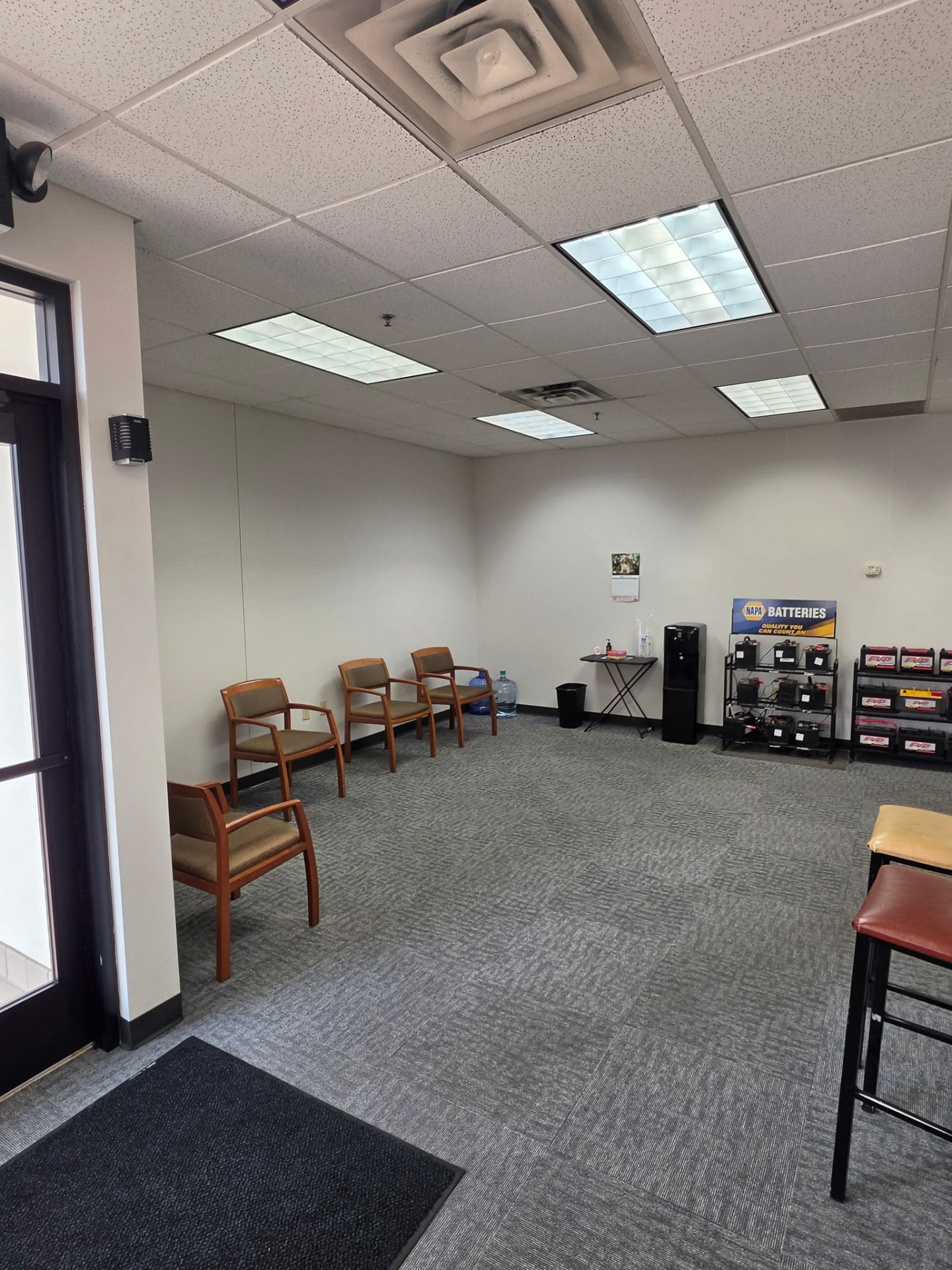 GDL Auto waiting area with seating and NAPA battery display